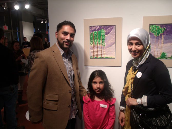 Ibrahim Moiz, father of kindergartner Asiya Moiz, a student at Al Fatih Academy, and her mom Sadaf Iqbal with Asiya’s work at the exhibition.