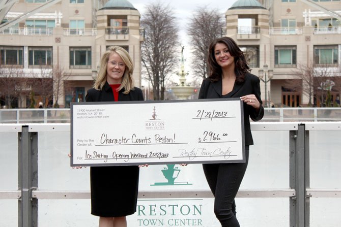 At Reston Town Center on Feb. 28, Cate Fulkerson (left), president of Reston Character Counts! Coalition, was presented with a donation check in the amount of $2,966 by Marissa Marwell (right), manager of the Reston Town Center ice skating pavilion.
