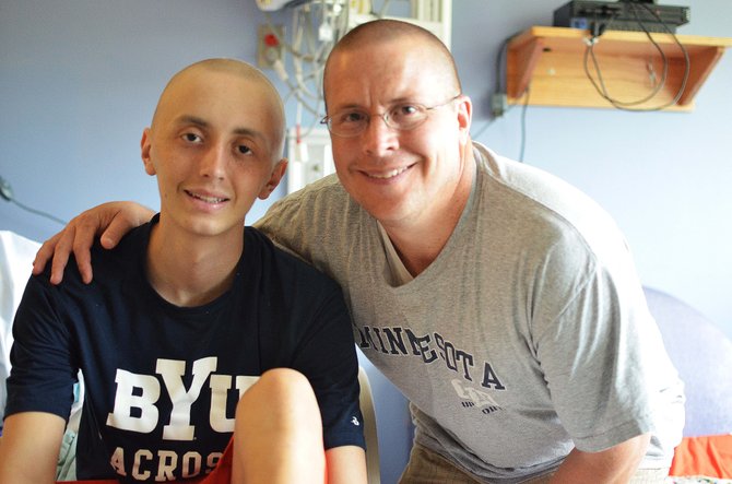 (From left) are Spencer Goold and dad Glen during Spencer’s treatment. His dad and a dozen friends shaved their heads in solidarity with Spencer when he lost his hair to chemo.