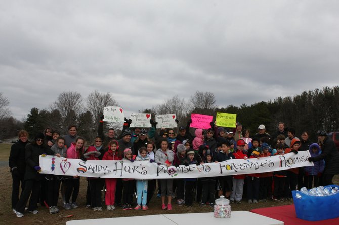 People came from Reston, Great Falls, Fairfax, Alexandria and Bethesda Sunday, March 3, to Lake Fairfax Park to run and walk 26 laps for each of the lost lives at Sandy Hook. First row, from left: Nina Paul, Sofi Blanco, Millie Blanco, Natalie Hutchinson, Bridget Crotty, Carly Hill, Faith Ann Finch, Erika Chung, Sydney Monserrate, Caden Southworth, Grady Gentile, Grant Kim, Grayson Miller, Emerson Miller, Ry Lindley, Cooper Girolamo, Nate Lindley, Harper Scruggs, Dawn Price.
Second row: Meg McGurn, Kim Finch, Maria Blanco, Juan Blanco, Leslie Hutchinson, Jonathan Hill, Cynthia Hill, Jennifer Gidwani, Hudson Gidwani, Ava Gidwani, Mahesh Gidwani, Emmery Gentine, Matt Gentile, Beth Colligan, Celia Dallas, Pheng Pan, Alex Yu, Lauren Thiell, Andrew Bolster, Liming Pan, Patricia Chung, Damon Griggs.
Third row: Martin McGurn, Glenn Finch, Chris Girolamo, Michelle Miller, Michael Southworth.