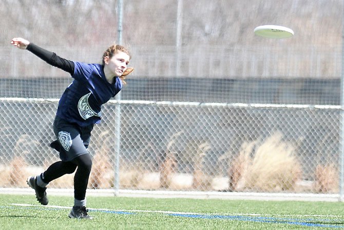 Allison Hahn sends the Frisbee down the field for the return throw after her team scored.