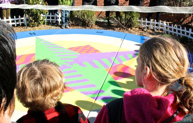 The 2nd grade students made their own Compass Rose pictures. The artwork was spread out on the floor and some of the designs were incorporated into the large one painted in the garden. 