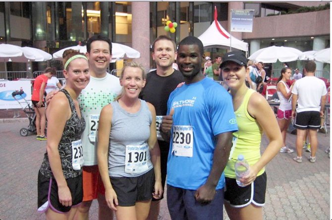 Terrill Jefferies, physical trainer and group running coach, enjoys a post race moment with friends in Crystal City. According to Jefferies, the most important part of racing is to have a training plan. Jefferies holds training runs every Saturday at Roosevelt Island starting at 12 p.m. For more information contact Jefferies at: tirelesstrainer@gmail.com. 