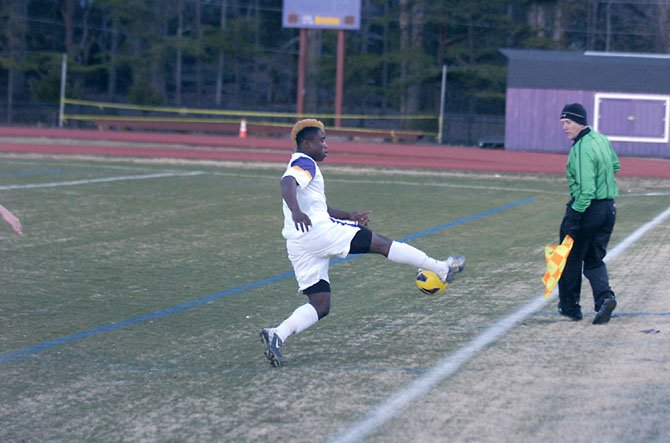 Lake Braddock senior Aaron Hollins chases down the ball near the sideline during a 3-1 victory against Robinson on March 22.