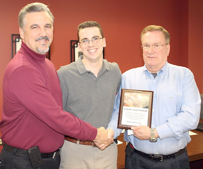 Northern Virginia Special Olympics Chairman Bill Ogletree and son Special Olympics Global Messenger Kevin Olgetree present a thank you plaque to Fairfax Adult Softball President John Carney.