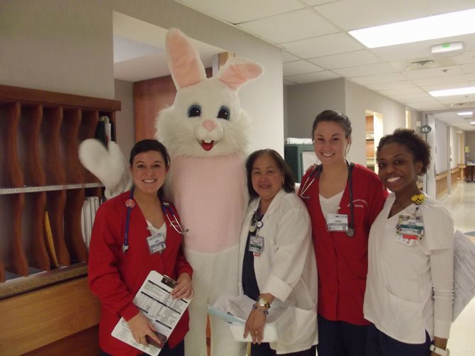 The Easter Bunny, portrayed by Winchester Sheriff Leonard Millholland, enjoys visiting with patients and hospital staff.