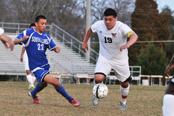 South Lakes senior Elvin Arbaiza, left, and Mount Vernon’s Erik Rodriquez go for the ball during Monday’s game at Mount Vernon High School.
