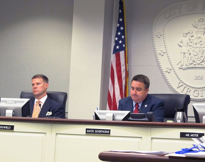 Fairfax City Council member Jeff Greenfield and Mayor R. Scott Silverthorne listen to residents during a public hearing on Tuesday, April 9, debating whether to remain in the water business.