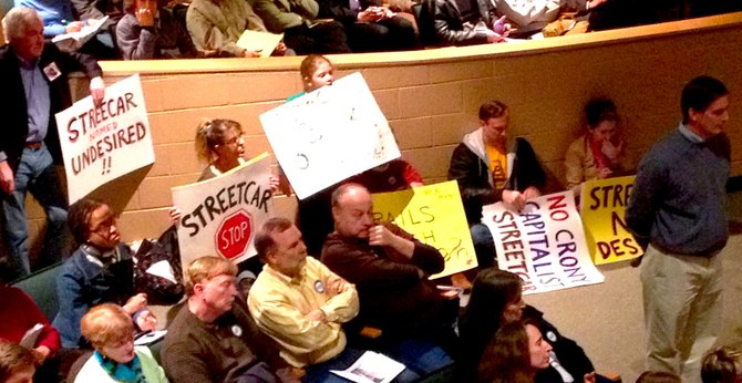 Opposition to the streetcar line waits to speak against the project. 