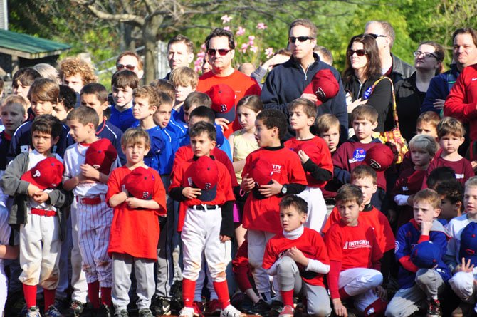 McLean Little League players and parents take a moment for the National Anthem during their opening day ceremony Saturday, April 13. 