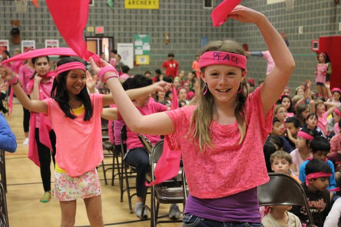 SCA Representative Caroline Keys (front) waves her pink bandana, building enthusiasm among the students for the anti-bullying pep rally.
