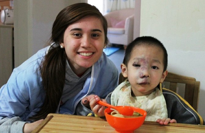 Vienna resident Charlotte Heffelmire with a Chinese orphan. Charlotte raised $5000 for Chinese orphanages and donated the funds to four orphanages while in China in early April.
