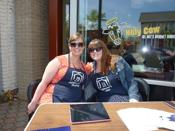 Kelly Andreae and Courtney Bishop raise funds for Carpenter's Shelter in front of Holy Cow restaurant in Del Ray. The organization raised $14,355 in 24 hours.
