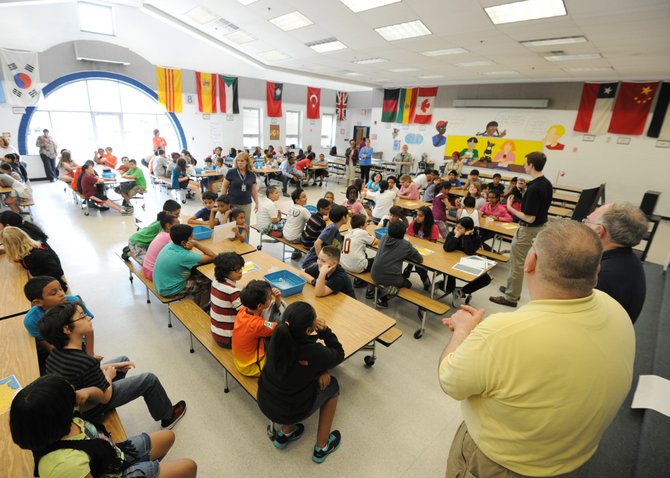 Geospatial analysts Ty Marr and Steve Bricker, members of National Geospatial-Intelligence Agency’s (NGA) 2010 oil spill response team, along with Patrick Henry College student and NGA intern Evan Johnson, speaking with fifth-grade students about the incident and the effort that went into limiting its effects on the environment.