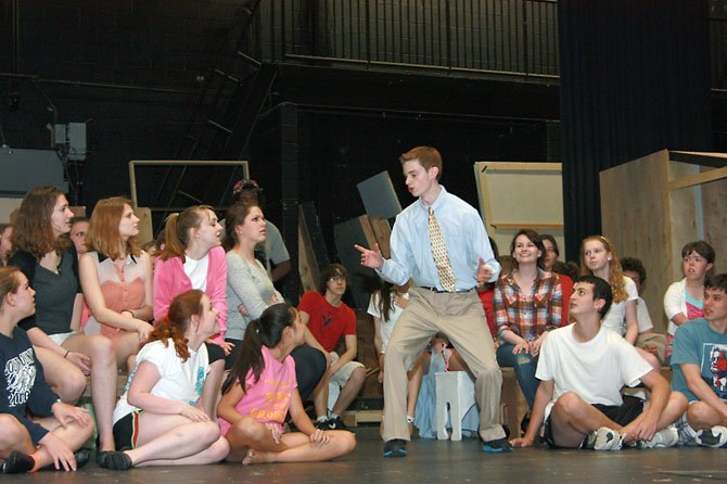 South County sophomore Jack Gereski as Harold Hill rehearses with the cast of “The Music Man.”