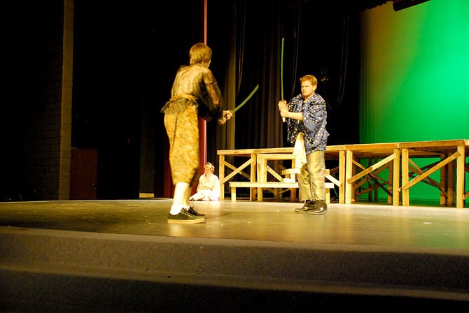 Sophomore Liam Finn (left) and senior Zach Newby (right) battle with samurai blades for the samurai’s wife, played by senior Sarah Beck (center).