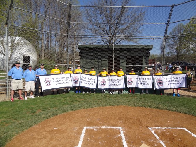 The 2012 Great Falls All Star team holding the banners of the championships that they won while they were Little Leaguers. This photo was taken as part of the Great Falls Little League Opening Ceremonies that were held last weekend as they were honored for their accomplishments.