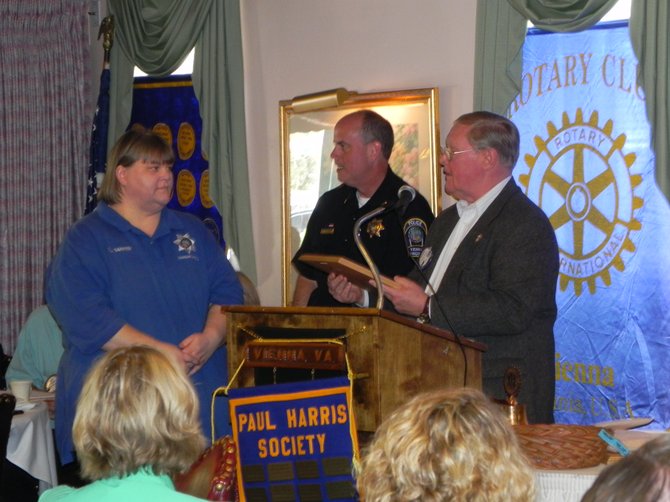 Tammy Barker; Chief Jim Morris, Vienna Police Department; Rotarian George Creed.
