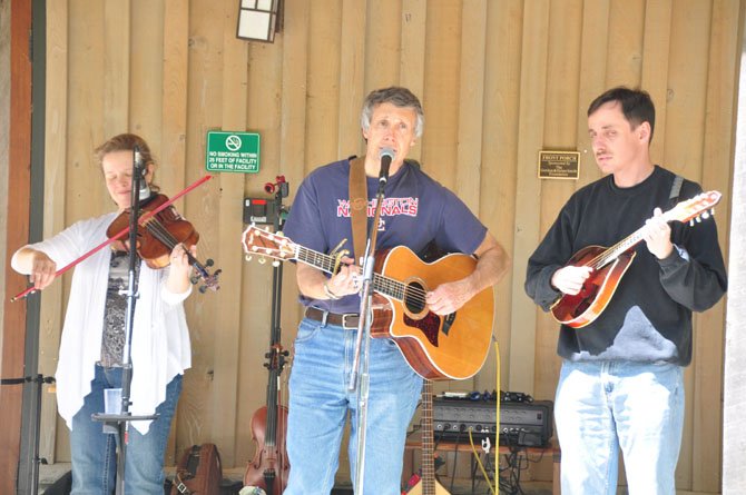 From left, Marcy Cochran, Tom Bodine and Steve Malyszka perform at the Walker Nature Education Center Saturday, May 4, as part of the Reston Spring Festival. 