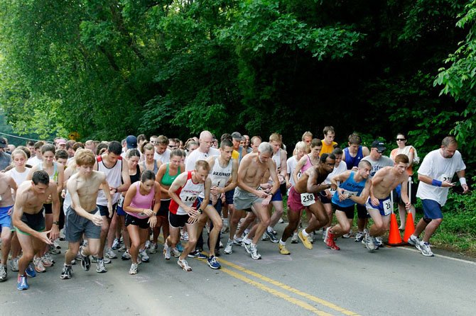 Runners take off from the starting line of a previous Clifton Caboose 5K Twilight Run.
