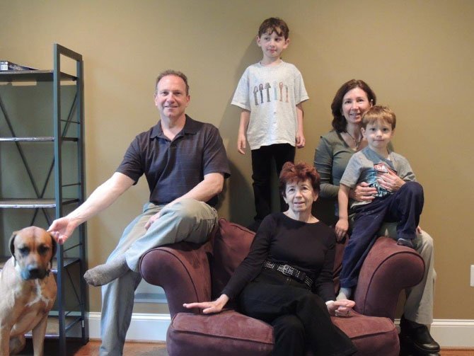 Noah Schnall stands behind his grandmother Barbara Mendeles, parents Michael and Barri Schnall with brother Ethan and family dog Buster.