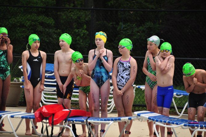 Swimmers at the Reston Youth Triathlon prepare to enter the water at the Ridge Heights Pool Sunday, May 12. 