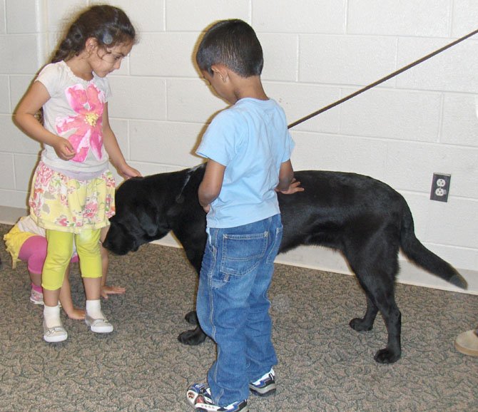 Children make friends with K-9 Spicey during the meeting.