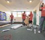 With the carpet laid, cove base molding is ...