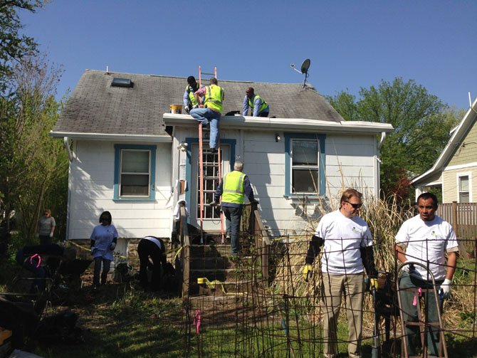 CBRE volunteers make roof repairs and clear out an Alexandria client's backyard as part of National Rebuilding Together Day April 27.