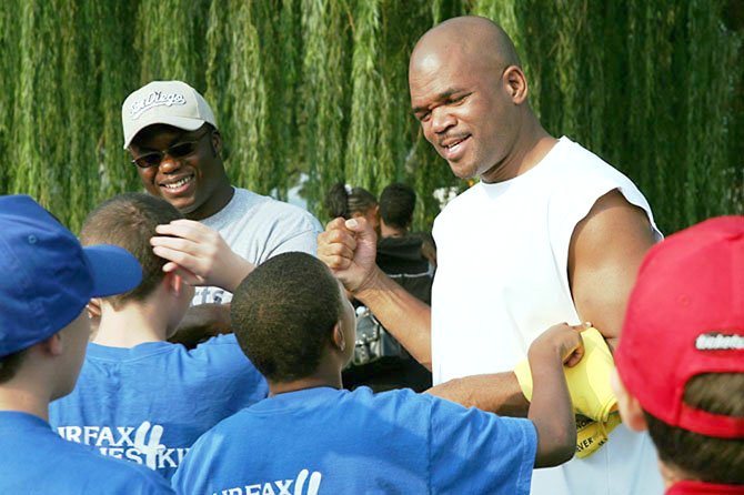 Pastor King Rhodes (left) has organized several 5K walks to benefit Fairfax Families4Kids, a mentoring program for foster youth. During the first fundraising walk in 2006, Rhodes enlisted the help of rapper Run DMC (right), who grew up in foster care.