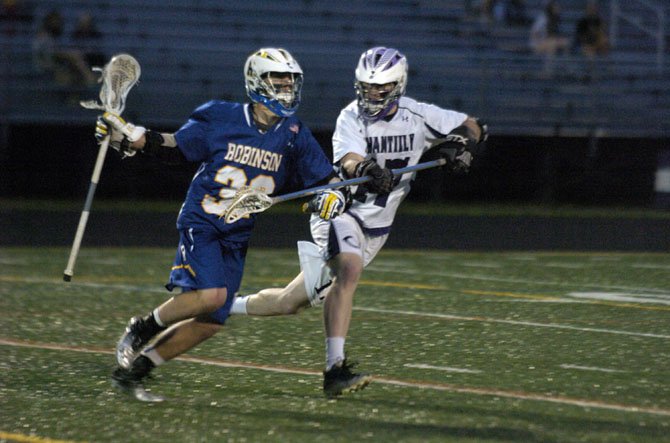 Chantilly sophomore Javin Re, right, defends Robinson’s Chris White on May 10 during the Concorde District boys’ lacrosse championship game.