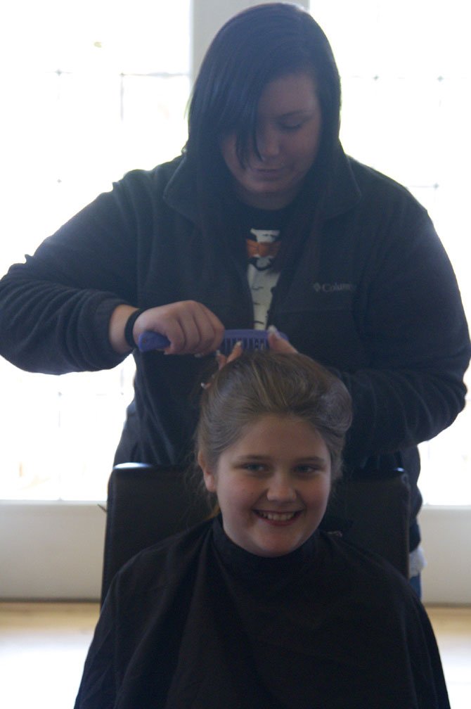 Ashley McGhee, a military spouse, volunteered to shave Sara’s and her best friend Ethan's heads.  

