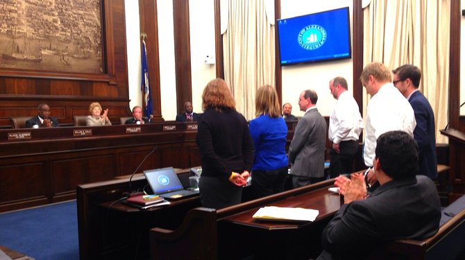 Budget officials stand and receive applause from City Council members shortly before the elected leaders approve the largest tax increase in living memory.