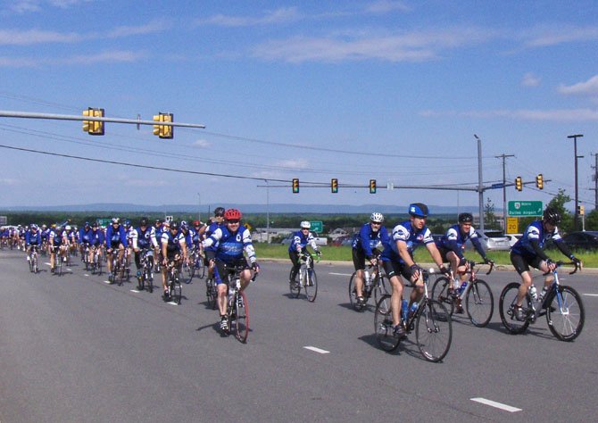 Centreville’s Kevin Whalen (in red helmet) helps lead Fairfax County’s Police Unity Tour contingent up Route 29, Sunday morning, toward the end of their 230-mile ride.

