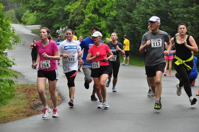 Runners make their way down Columbine Street, the home stretch of the Joe Cassella 5K Sunday, May 19. 