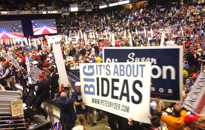 Supporters parade through the Coliseum as they wait for the ballots to be counted.