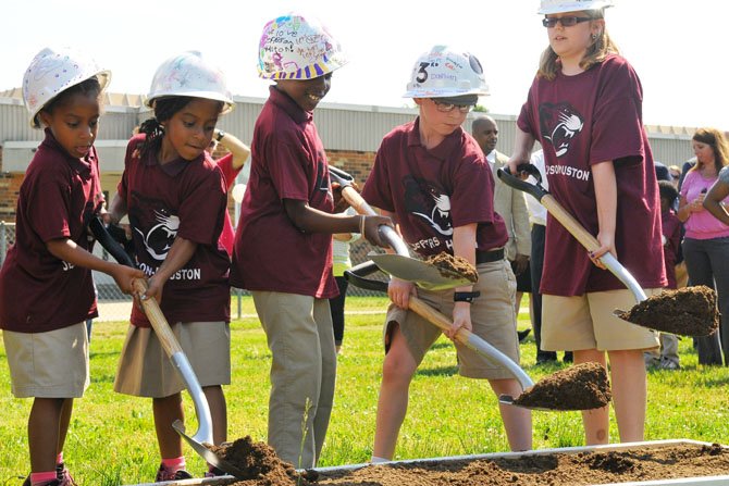 Student representatives from Jefferson-Houston Elementary School perform a groundbreaking in the ceremony for the new school.  

