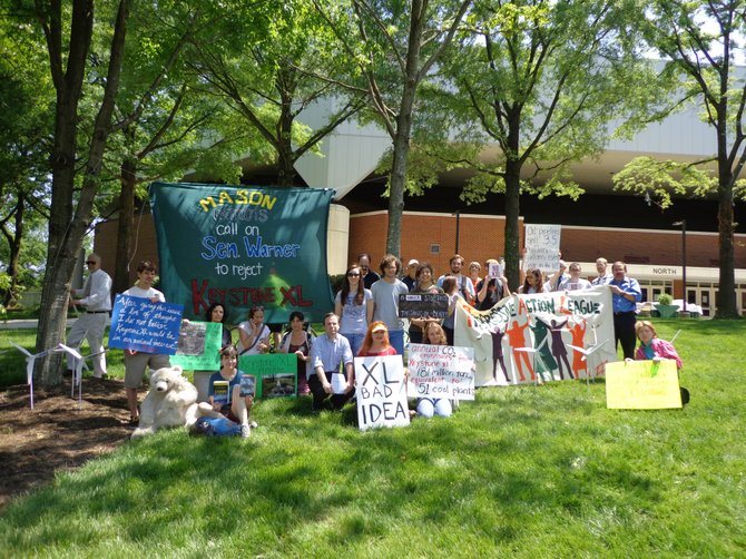 More than 30 GMU protesters rallied Friday, May 17 in advance of Sen. Mark Warner's commencement address to oppose the Keystone XL tar sands pipeline.