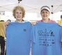 Volunteers Linda Rae and Claire Rubin display t-shirts ...