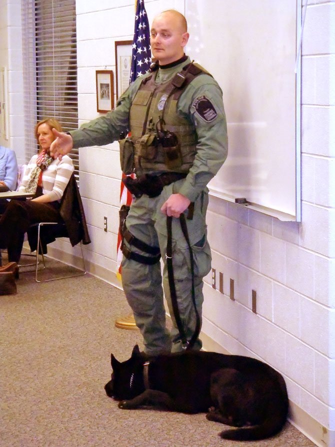OLYMPUS DIGITAL CAMERA 
K-9 Officer Matthew Kunstel talks about his job while his partner, Max, relaxes.

