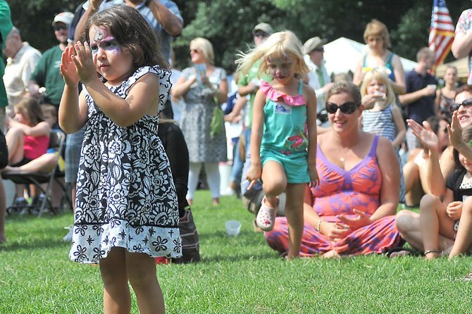 Bella Miner applauds as the Irish dancers conclude their performance at the 2012 Ballyshaners’ Irish Festival.

