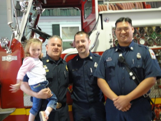 Delaney Saslav with firefighters (from left) Richard Merrill, Jason Branham and Travis Nguyen.