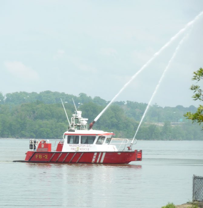 D.C. Fireboat John Glenn Jr. demonstrates a water cannon salute along the Potomac River as part of the 133rd annual flag raising at the Old Dominion Boat Club.

