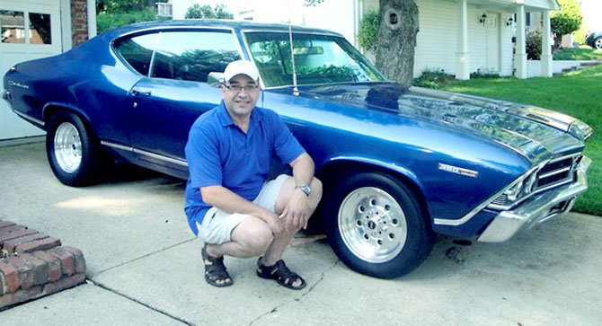 Retired Lt. Col. Edward “Eddie” Amoros in front of his 1969 Chevelle Malibu, one of the cars featured at Carfest 2013. Amoros is the historian of American Legion Post 176.
