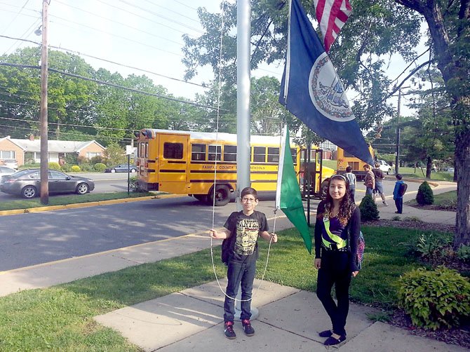 Raul Rodrigez and Michelle Rodrigez, students at Lynbrook Elementary, hang air quality flags as part of the U.S. Environmental Protection Agency's School Flag Program, which help teachers and students know what the air quality is expected to be daily. The school is the first in the county to adopt the program. 