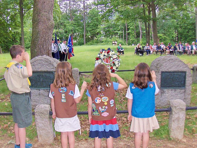 Scouts salute the monuments of Generals Isaac Stevens and Philip Kearny in Ox Hill Battlefield Park.
