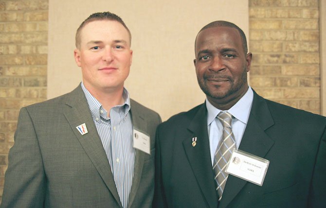 Retired Marine Sgt. T.J. Brooks and retired Army Sgt. DeWitt Osborne are Wounded Warriors who have benefited from the golf program at Ft. Belvoir.