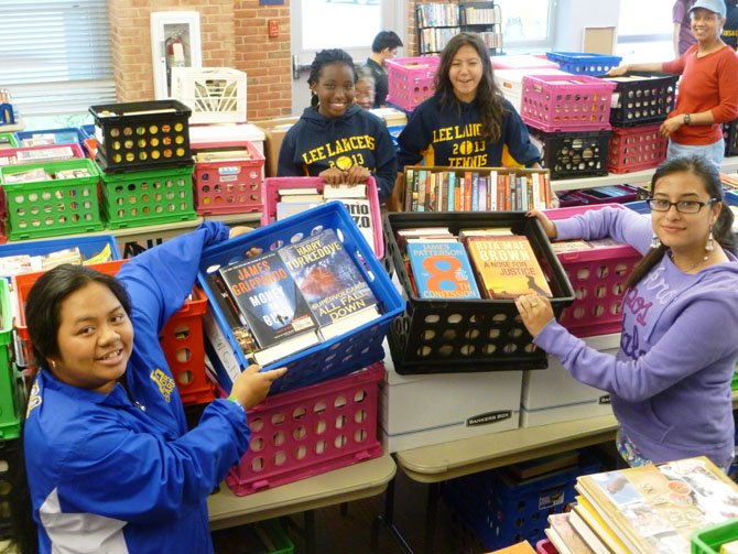 Members of the Lee High School Tennis Team unloaded hundreds of crates of books for the Richard Byrd Mystery Book Sale beginning Thursday, May 30.