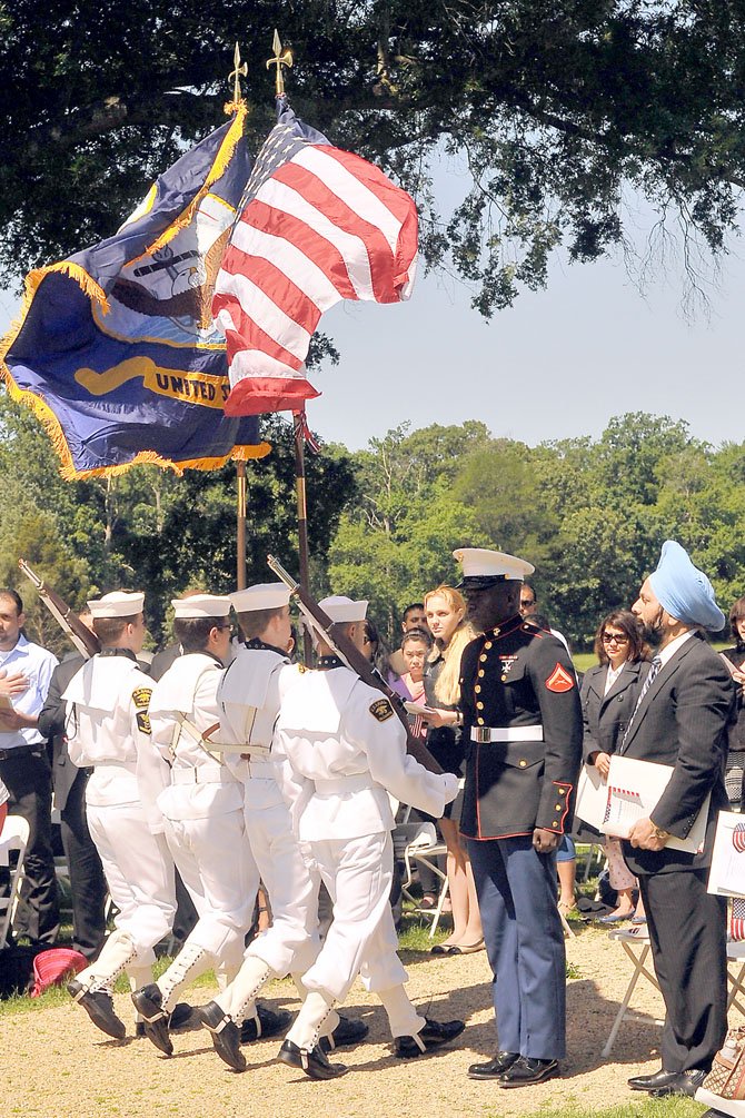 The honor guard of the Alexandria Division of the U.S. Sea Cadet Corps retires the colors.