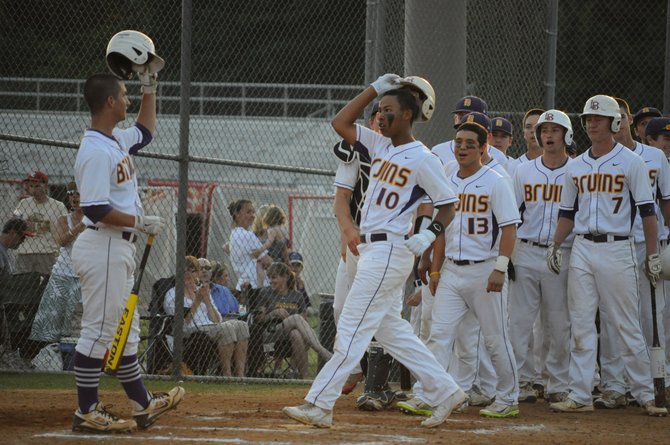 Lake Braddock third baseman Alex Lewis (10) is greeted at home plate by Thomas Rogers after hitting a solo home run against Marshall on Wednesday in the Northern Region semifinals.